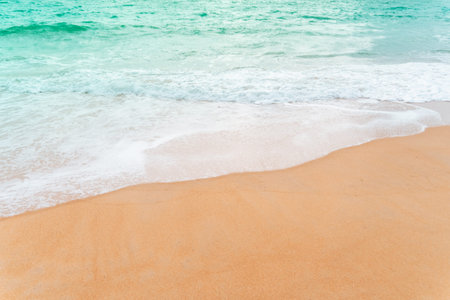 Top view of sand and water clean beach and white sand in summer with sun light blue sky and bokeh...
