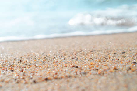 Top view of sand and water clean beach and white sand in summer with sun light blue sky and bokeh abstract  background.の写真素材