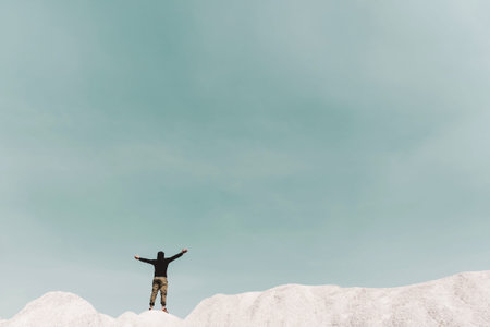 Man rise hands up to sky freedom concept with copyspace blue sky background.