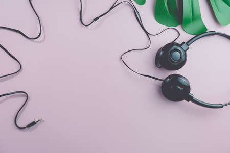 Top view of black headphones on white or pastel color background. Music concept.の写真素材