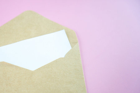 Card with envelope,has space for text. A brown envelope with a blank piece of white paper.