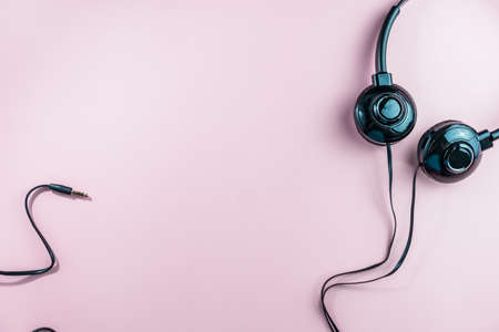 Top view of black headphones on white or pastel color background. Music concept.の写真素材