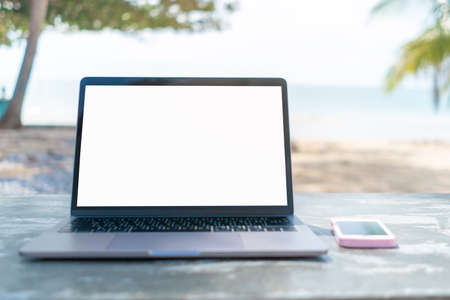 Top view of business woman hand using modern laptop or notebook with phone to work. Office desktop on table background.の写真素材