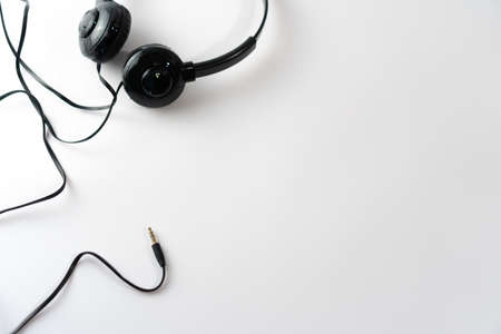Top view of black headphones on white or pastel color background. Music concept.の写真素材