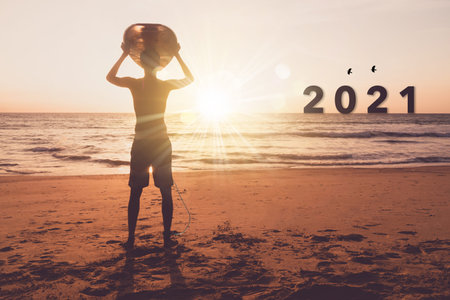 New year 2021 is coming with sunset beach background. New start for planing or set new resolution in...