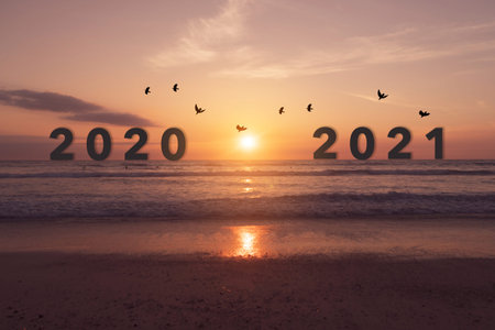 New year 2021 is coming with sunset beach background. New start for planing or set new resolution in...