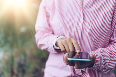 Woman hand using smartphone to do work business, social network, communication with city view...