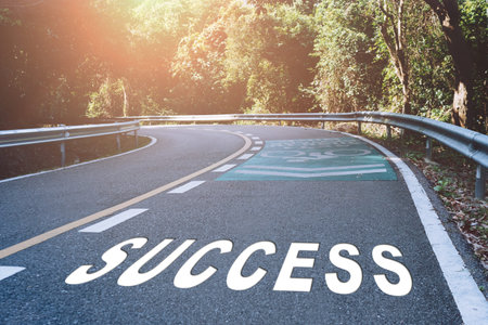 Success word on road in wood represents the beginning of a journey to the destination in business planning, strategy and challenge or career path, opportunity concept.の写真素材