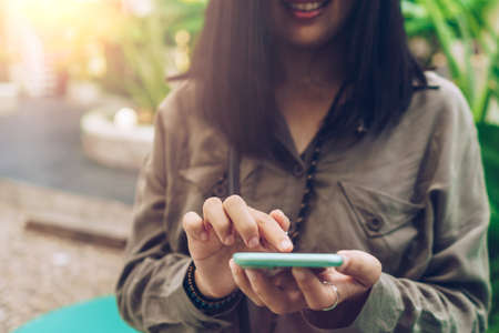 Woman hand using smartphone to do work business, social network, communication concept.の写真素材
