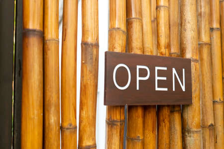 A business sign that says open on cafe or restaurant hang on door at entrance. Vintage color tone style.の写真素材