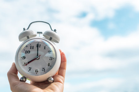 Selective focus of alarm clock with nature bokeh background. lifestyle  productive life concept.
