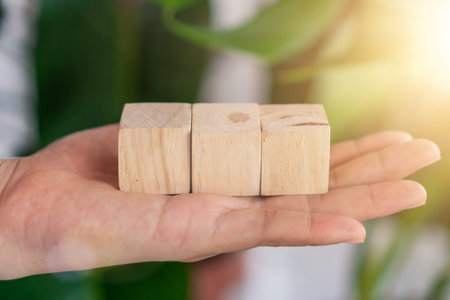 Blank wooden cube that you can put text or icon on in hand hold background
