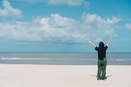 Copy space freedom lady hand rising up summer vacation and freedom concept blue sky and mountain in abstract summer background. Vintage clean color tone styleの写真素材