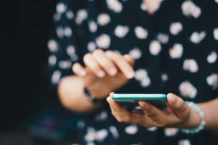 Woman hand using smartphone to do work business, social network, communication concept.の写真素材