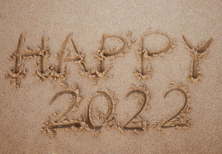 Happy 2022 word on the sand at the beach to show life ahead next year copyspace backgroundの写真素材