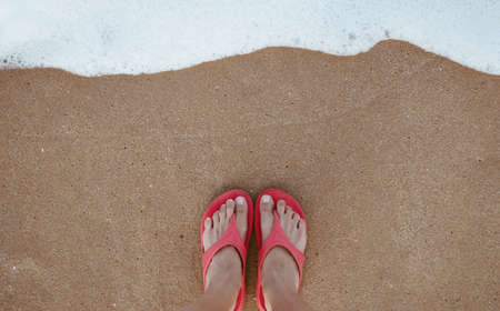 Summer vacation concept barefoot on sand at beach with copyspace backgroundの写真素材