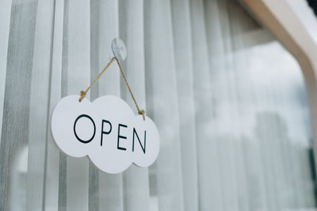 A business sign that says Open on cafe or restaurant hang on door at entrance. Vintage color tone...