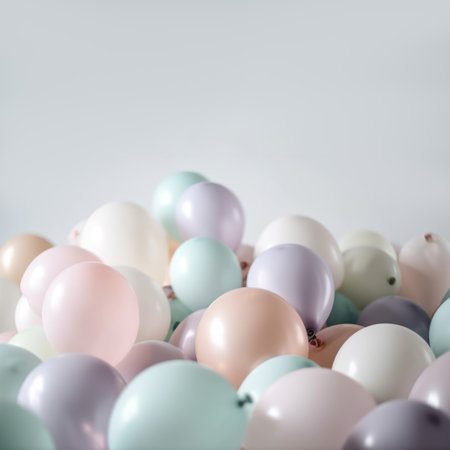 Pastel colorful balloons in white room background. Party and celebration.の素材
