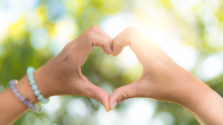 Hand do heart shape mean love on nature bokeh background.の写真素材