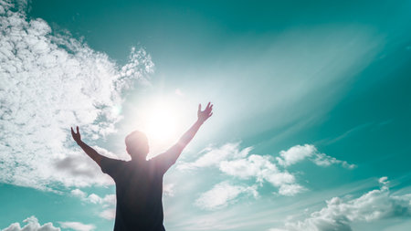 Man rise hand up to amazing blue sky feel never give up and freedom.の写真素材