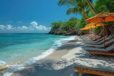 A tropical beach paradise with powdery white sand and swaying palm trees. The emerald waters gently lap against the shore.の素材