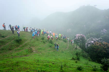 climbers at Jilongding mountain peak with dense fogのeditorial素材