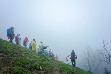 climbers at Jilongding mountain peak with dense fogのeditorial素材