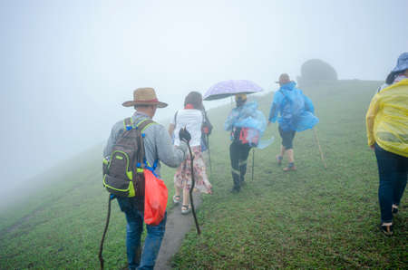 climbers at Jilongding mountain peak with dense fogの写真素材