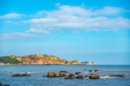 Rocks in the shallow sea and mid-levels islandの写真素材