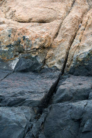 Black stones by the seaの写真素材