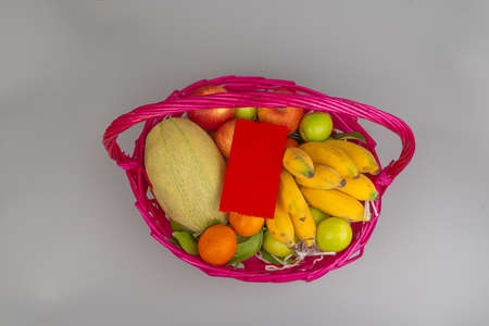 Pink basket filled with fruitsの写真素材