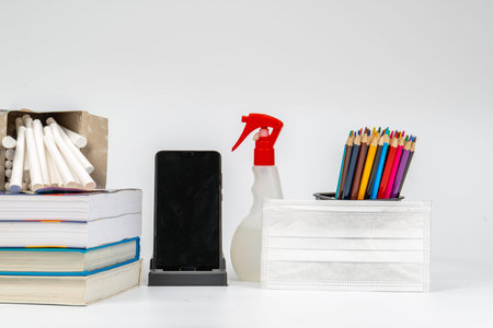 online class room still life material with mask, sanitiser and mobile phone