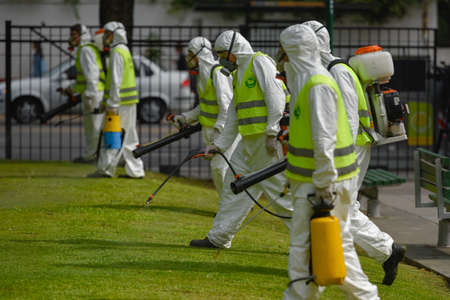 Buenos Aires, Argentina - March 3, 2016: Employees of the Ministry of Environment and Public Space fumigate for Aedes aegypti mosquitos to prevent the spread of zika virus and Dengue fever in park.のeditorial素材