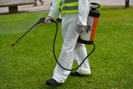 Buenos Aires, Argentina - March 3, 2016: Employee of the Ministry of Environment and Public Space fumigates for Aedes aegypti mosquitos to prevent the spread of zika virus and Dengue fever in park.のeditorial素材