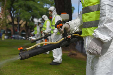 Buenos Aires, Argentina - March 3, 2016: Employees of the Ministry of Environment and Public Space fumigate for Aedes aegypti mosquitos to prevent the spread of zika virus and Dengue fever in park.のeditorial素材
