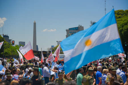 Buenos Aires, Argentina - Dec 10, 2015: Supporters of the newly elected Argentine president cross the 9 de Julio Avenue in front of the Obelisk.のeditorial素材