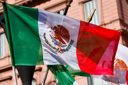 Mexican flag weaving on a pink building backgroundの写真素材