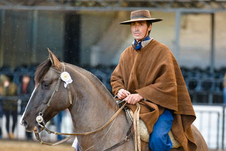 Buenos Aires, Argentina - Jul 16, 2016: A gaucho cowboy riding a horse during a show at the Rural Exhibition.のeditorial素材