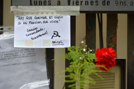 Flowers and sign on a fence at the Embassy of Cuba in Buenos Aires, Argentina.のeditorial素材