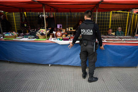 Buenos Aires, Argentina - 24 Jun, 2017: A policeman talking with seller at the souvenir shop in Palermo neighborhood.のeditorial素材