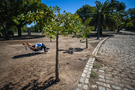 Buenos Aires, Argentina - 1 Apr, 2017: A Woman is sunbathing in the Palermo Woods urban park (Spanish: Bosques de Palermo, Parque Tres de Febrero).のeditorial素材