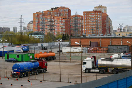Moscow, Russia. 2nd May, 2020. View of the parking lot with trucks carrying bitumen and bedroom suburb on background in Moscow, Russia.のeditorial素材