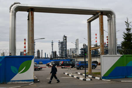Moscow, Russia. 2nd May, 2020. Parking lot with cars and pipes on background of the Moscow Oil Refinery in the Chagino-Kapotnya industrial zone in Moscow, Russia.のeditorial素材