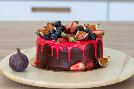 tasty cake with fig fruits, grapes and a strawberry