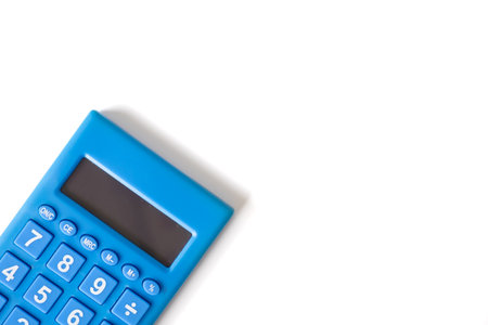 A modern blue calculator sits diagonally on a clean white background, symbolizing finance, calculation, and simplicity in business and education concepts.の写真素材