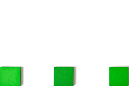 Three isolated green wooden blocks evenly spaced on white background, representing separation, diversity, and independent elements. Minimalist concept symbolizing division and choice.の写真素材