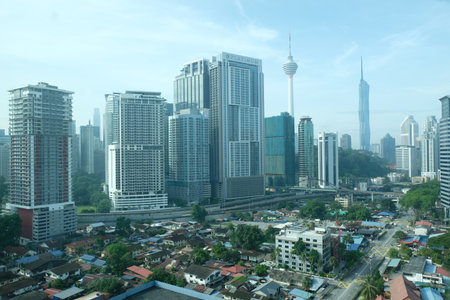Kuala Lumpur, Malaysia - November 2, 2025: Kuala Lumpur skyline with KL Tower and Merdeka 118 above urban neighbourhoods on a clear morning.のeditorial素材