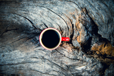 Coffee cup with beautiful nature and lighting on wood background.の写真素材