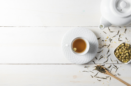 Hot tea with tea pot on white wood background.の写真素材