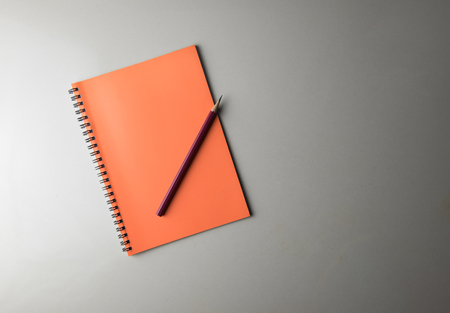 top view blank notebook and pencil on white deskの写真素材